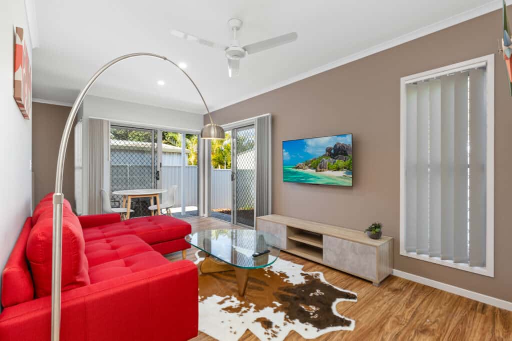 Modern living room in Brisbane rooming house with stylish decor and outdoor access.
